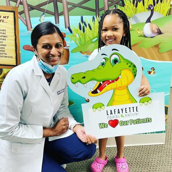 Dr. Gouri with a patient smiling at the camera